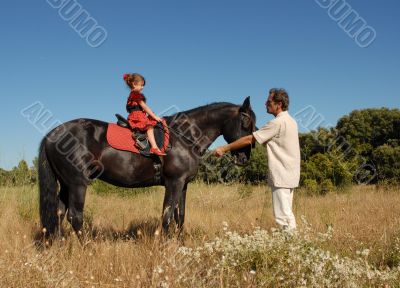 father, daughter and horse