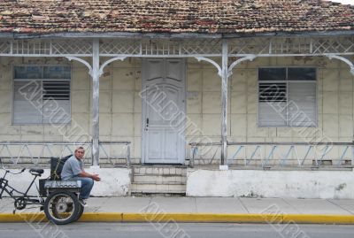 bike taxi parked in front of old house