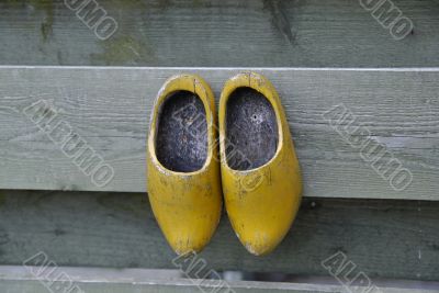 Clogs hanging on a fence