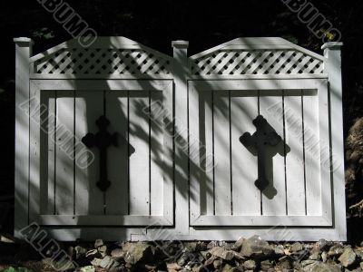 black cross on white wooden doors