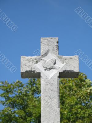 stone cross with blue sky