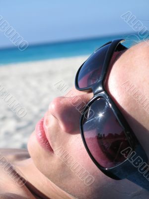 female with shades on the beach