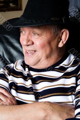 Grandfather with a black cowboy hat posing