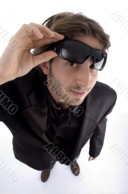 standing man holding sunglasses