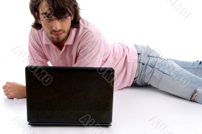 laying man with laptop