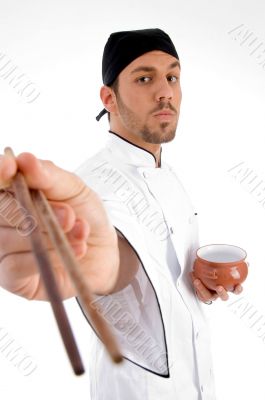 chef with chopsticks and bowl