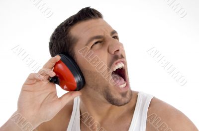 young guy enjoying rock music with full volume