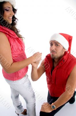 man proposing to the woman with christmas hat