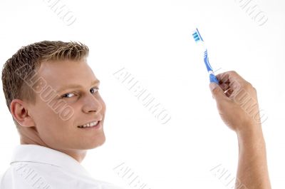 adult caucasian holding toothbrush