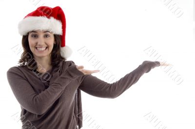 young female in christmas hat with open palms