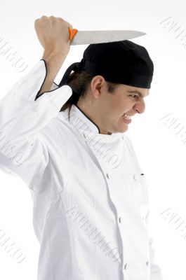 angered chef posing with knife
