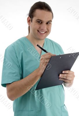 handsome surgeon writing prescription