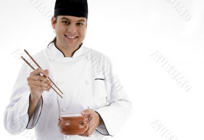 chef presenting chinese dish with chopstick
