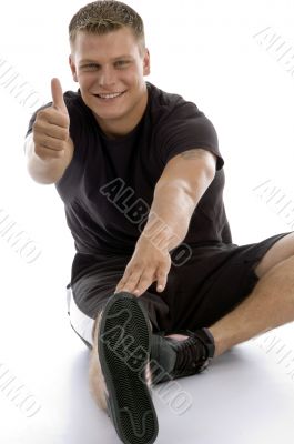 exercising man showing good luck sign
