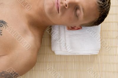 man relaxing with his eyes closed at spa