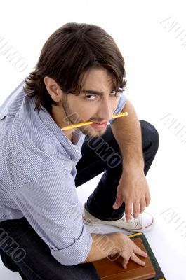 student holding pencil in mouth