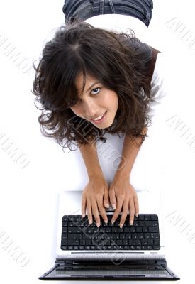 young female lying on floor working on laptop