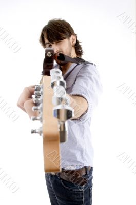 young fellow holding guitar like gun