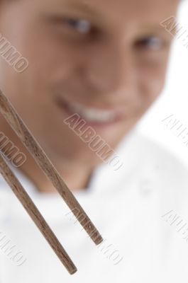 close up of chopsticks and chef in blur motion