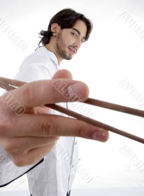 young fellow in chef uniform holding chopsticks