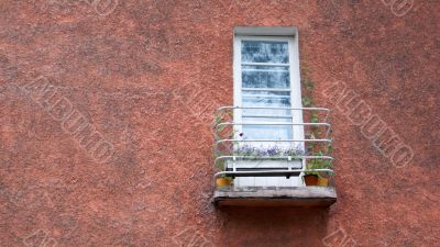 old balcony with flowers on the wall