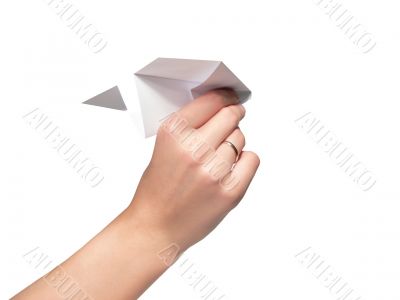 The female hand starts the paper plane. Isolated.
