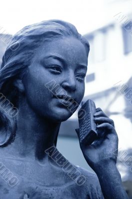 statue at the phone