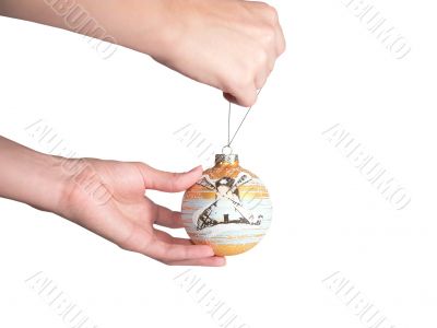 The female hand hangs up fur-tree a toy. New year. The female hand hangs up fur-tree a toy. New year.