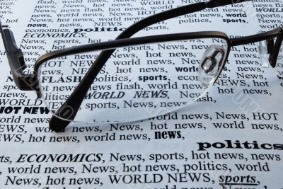 glasses above a newspaper