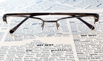 glasses above a newspaper
