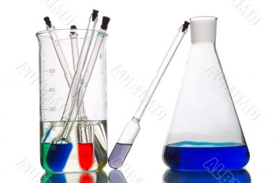 a lot of retorts with liquids of different colour