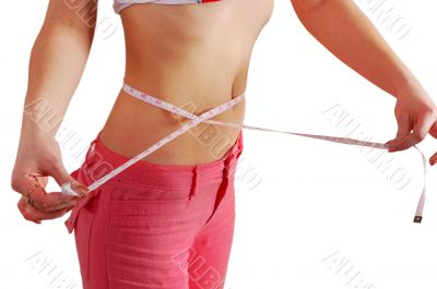 woman measuring her waist with a measuring tape
