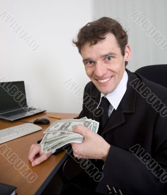 The man holds dollars