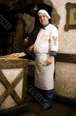 Cook cooking on the kitchen.