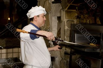 Cook cooking on the kitchen.