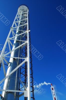 Industrial pipes and ladders on the blue sky
