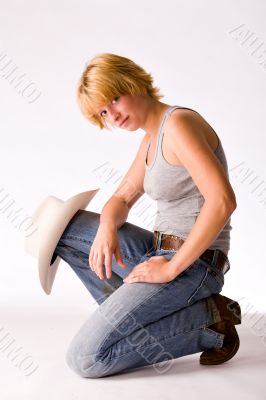 Portrait of a red haired Cowgirl sitting on her knee