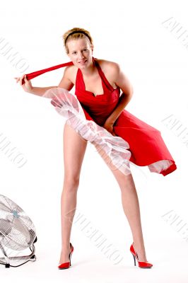 Funny girl in red gala dress playing sexy with a ventilator