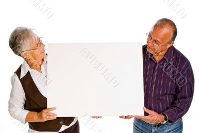 man &amp; woman holding a blank over white background