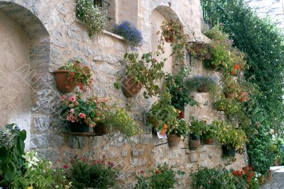 Spello - Potted plants and flowers hanged to an old house