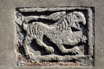 Ancient stone panel on a church in Tuscany