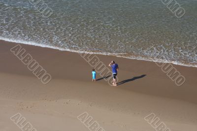 Father and son playing on the beach