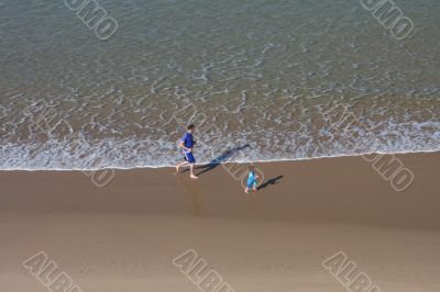 Father and son playing on the beach