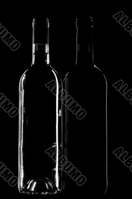Two wine bottle on black