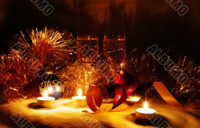 Two glasses of champagne lightening with candle in new year stuf