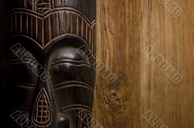 African mask over wooden background