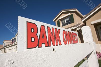 Bank Owned Real Estate Sign and House with American Flag