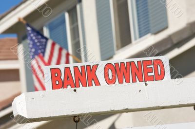 Bank Owned Real Estate Sign and House with American Flag