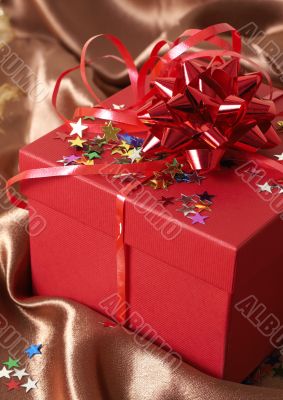 Red gift box with bows and stars