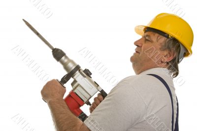 Worker with drilling machine and safety helmet